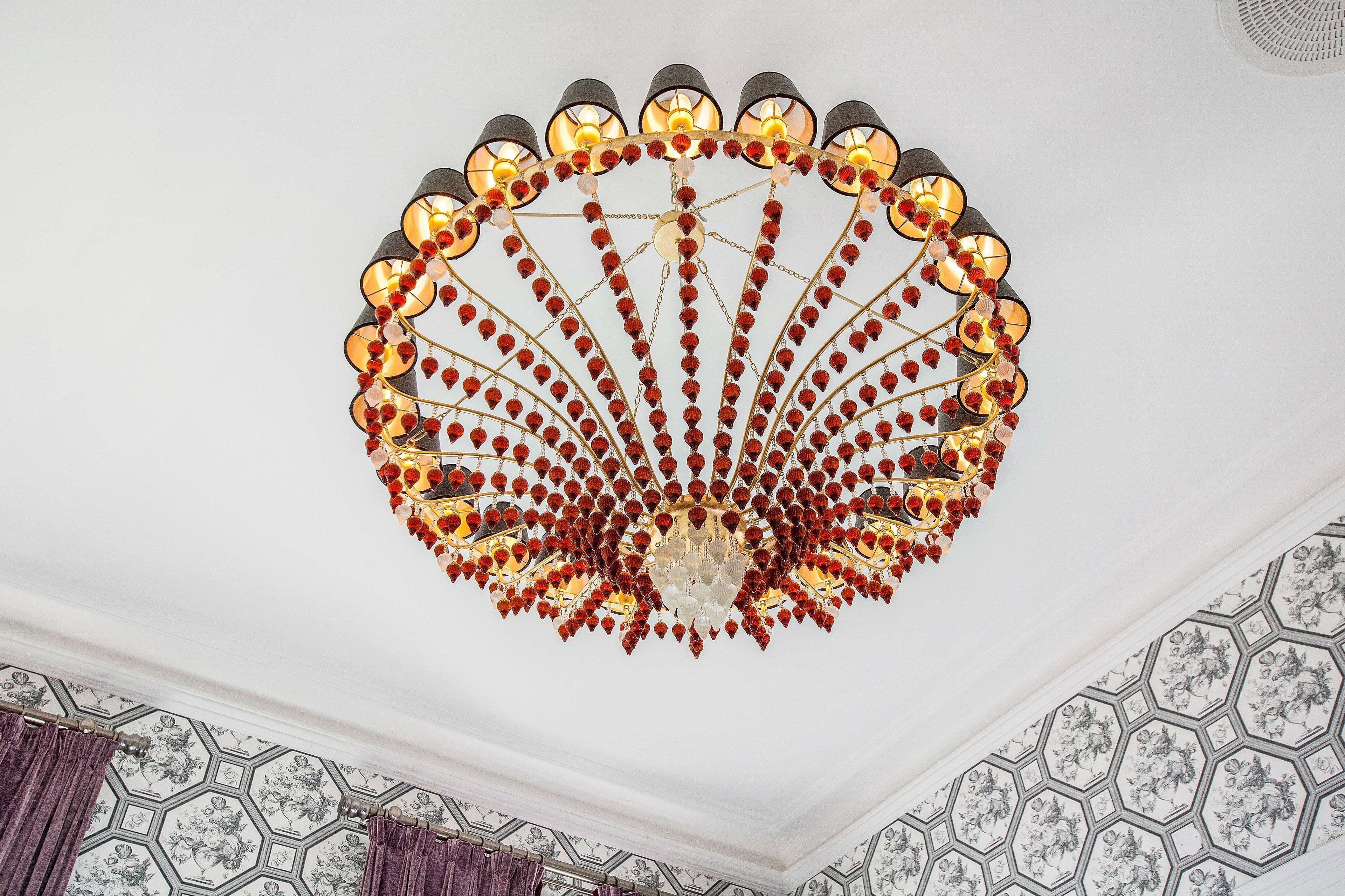 A chandelier with a central crystal surrounded by multiple tiers of lights.