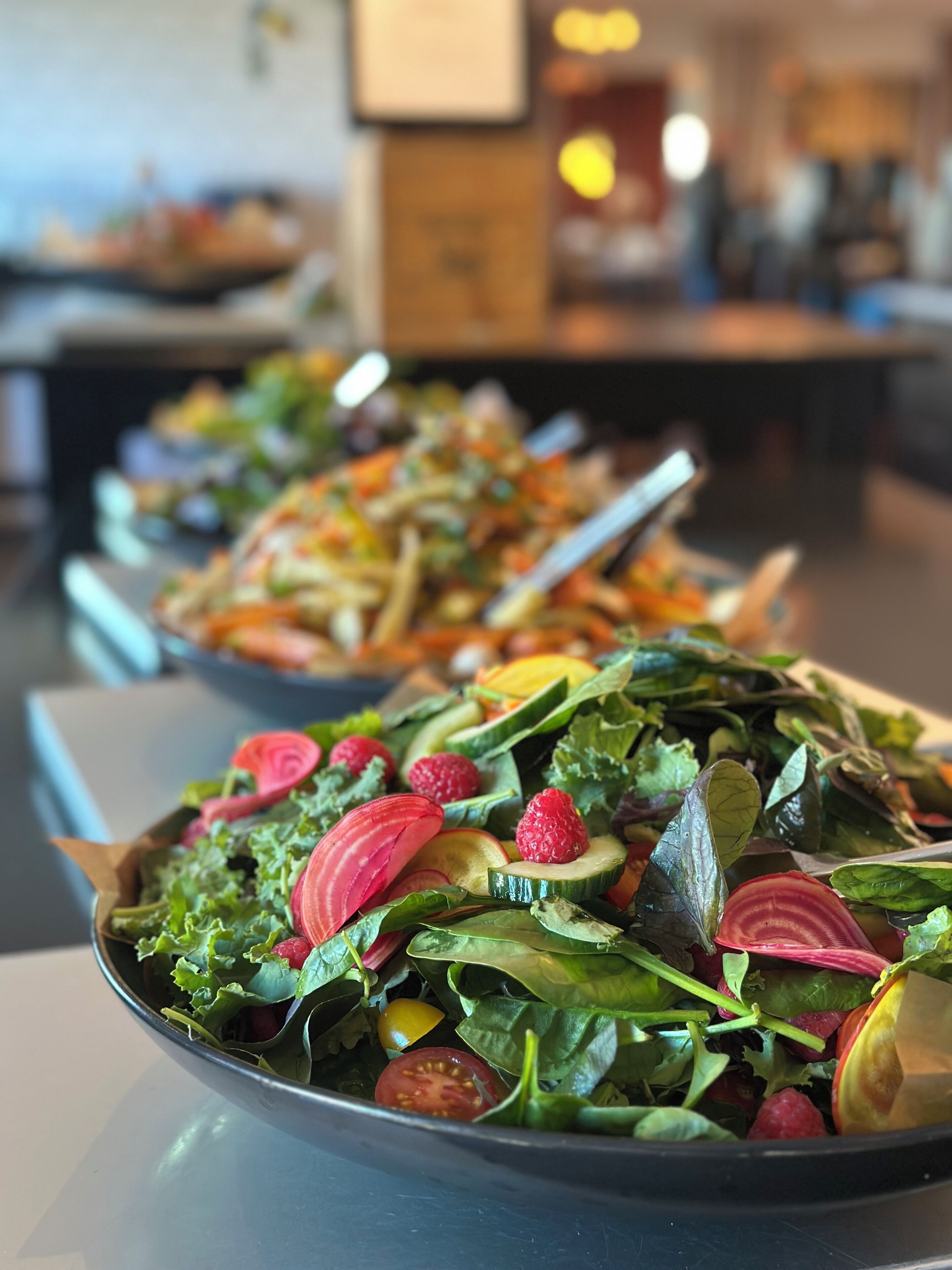 A restaurant with a variety of dishes displayed on the counter.
