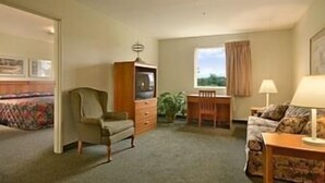 A room with a bed, a TV, a desk, and a chair. - Super 8 by Wyndham Hagerstown/Halfway Area (Hagerstown)