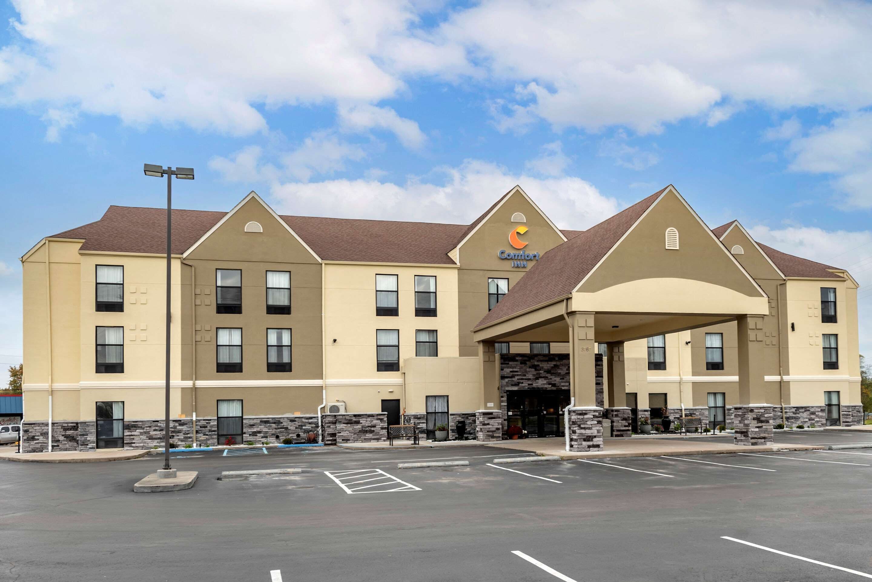 A Comfort Inn hotel with a two-story structure, a covered entrance, and a parking lot.