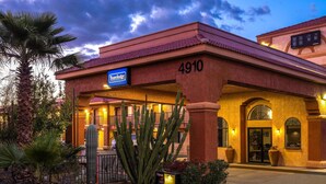 A Travelodge hotel with a red facade, number 4910, and a signboard. - Travelodge by Wyndham Tucson AZ (Tucson)
