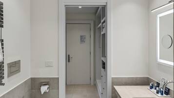 A modern bathroom with a toilet, bidet, and sink.