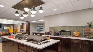 A modern kitchen with a central island, built-in appliances, and a variety of food items. - Homewood Suites by Hilton Columbus/Polaris, OH (Columbus)