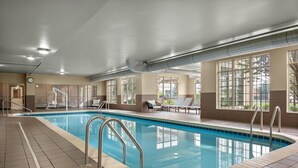 An indoor swimming pool with clear water, surrounded by lounge chairs and a tiled floor. - Homewood Suites by Hilton Columbus/Polaris, OH (Columbus)