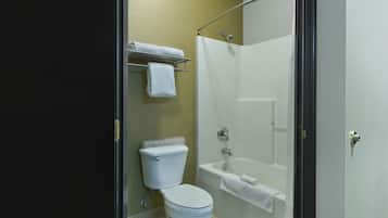 A bathroom with a toilet, a bathtub, and a shower curtain.