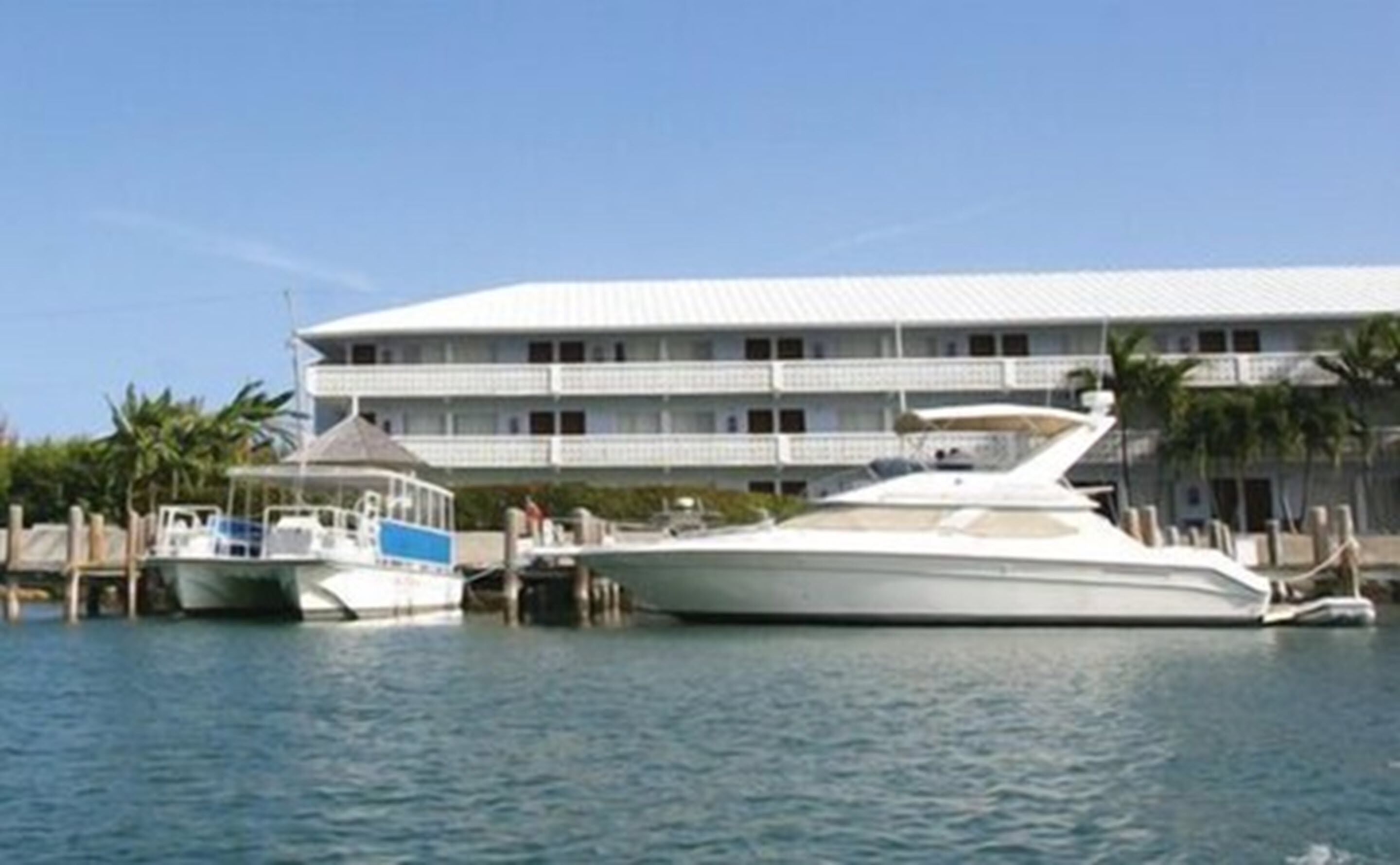 A large, modern hotel with a white facade and multiple balconies.