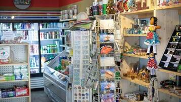 A store with shelves stocked with various items, including snacks and toys.