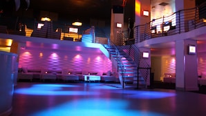 A spacious lobby with a central staircase, multiple seating areas, and a modern design. - Shephard's Beach Resort (Clearwater Beach)