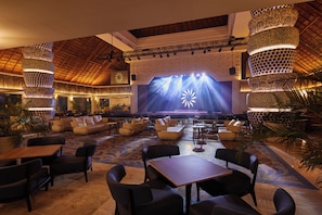 A spacious lobby with a stage, seating areas, and decorative lighting. - Bahia Principe Explore Akumal - Hyatt Inclusive Collection - All Inclusive (Akumal)