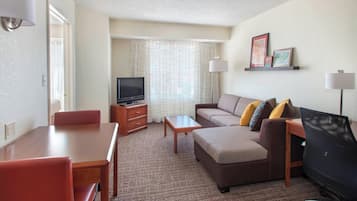 Premium bedding, desk, laptop workspace, blackout drapes