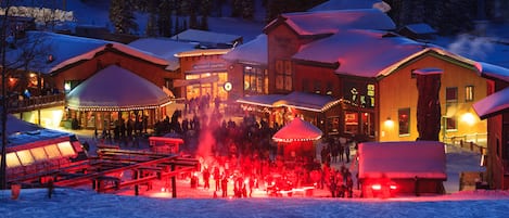 A snow-covered lodge with multiple buildings, including an activity center and a restaurant.