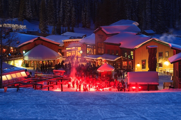 A snow-covered lodge with multiple buildings, including an activity center and a restaurant.