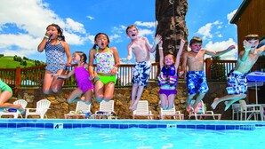 A group of people jumping into a swimming pool. - Grand Targhee Resort (Alta)