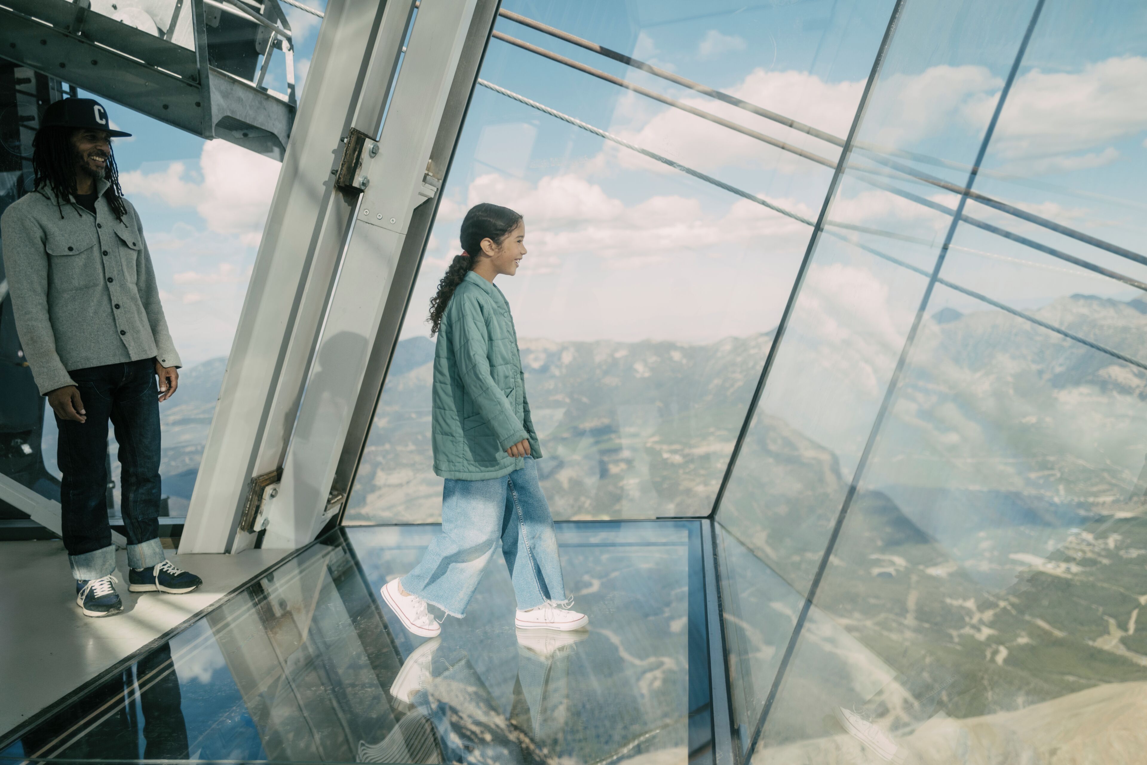 A glass floor with a view of a mountainous landscape.