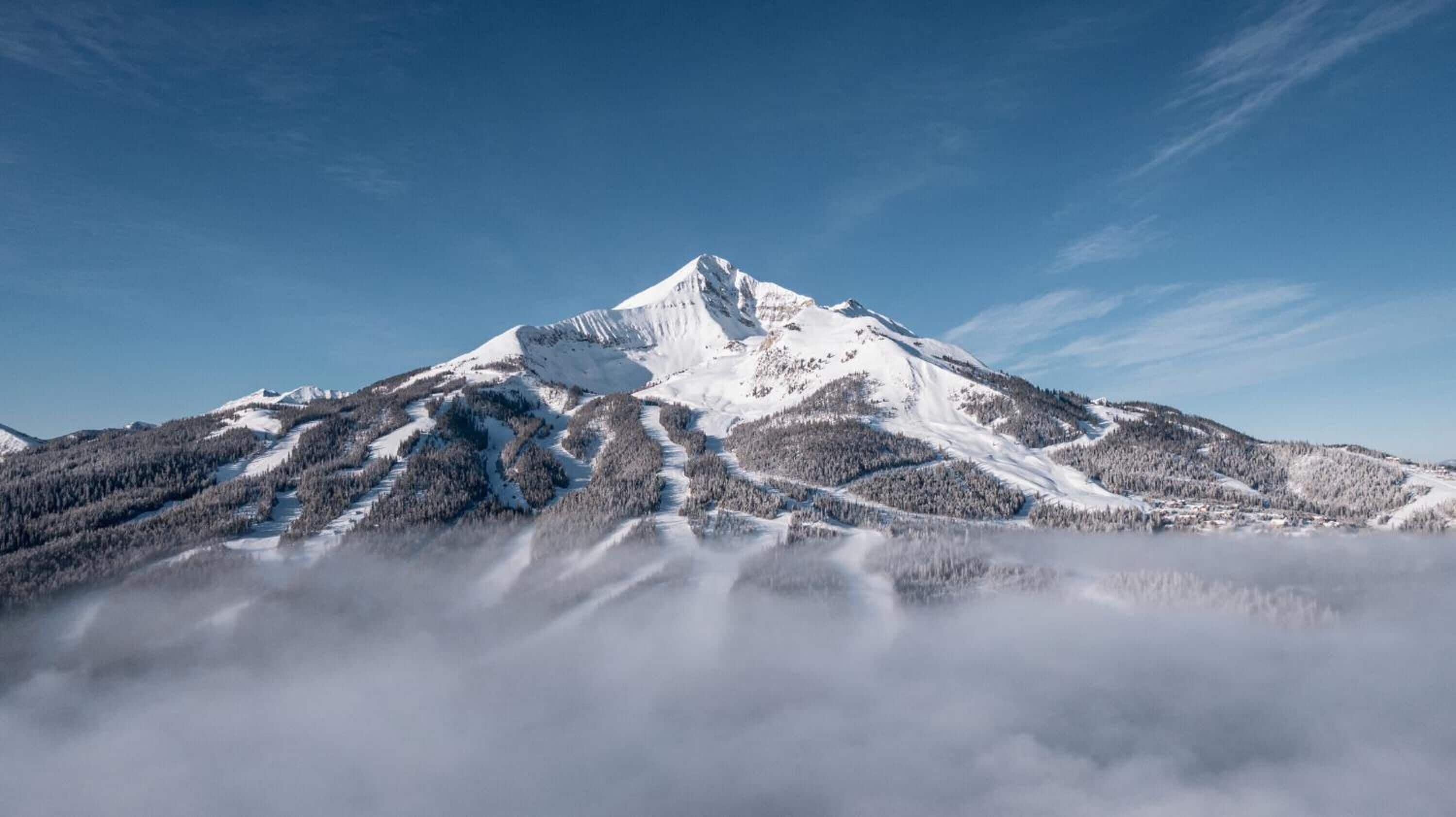 A snow-covered mountain with a clear sky.