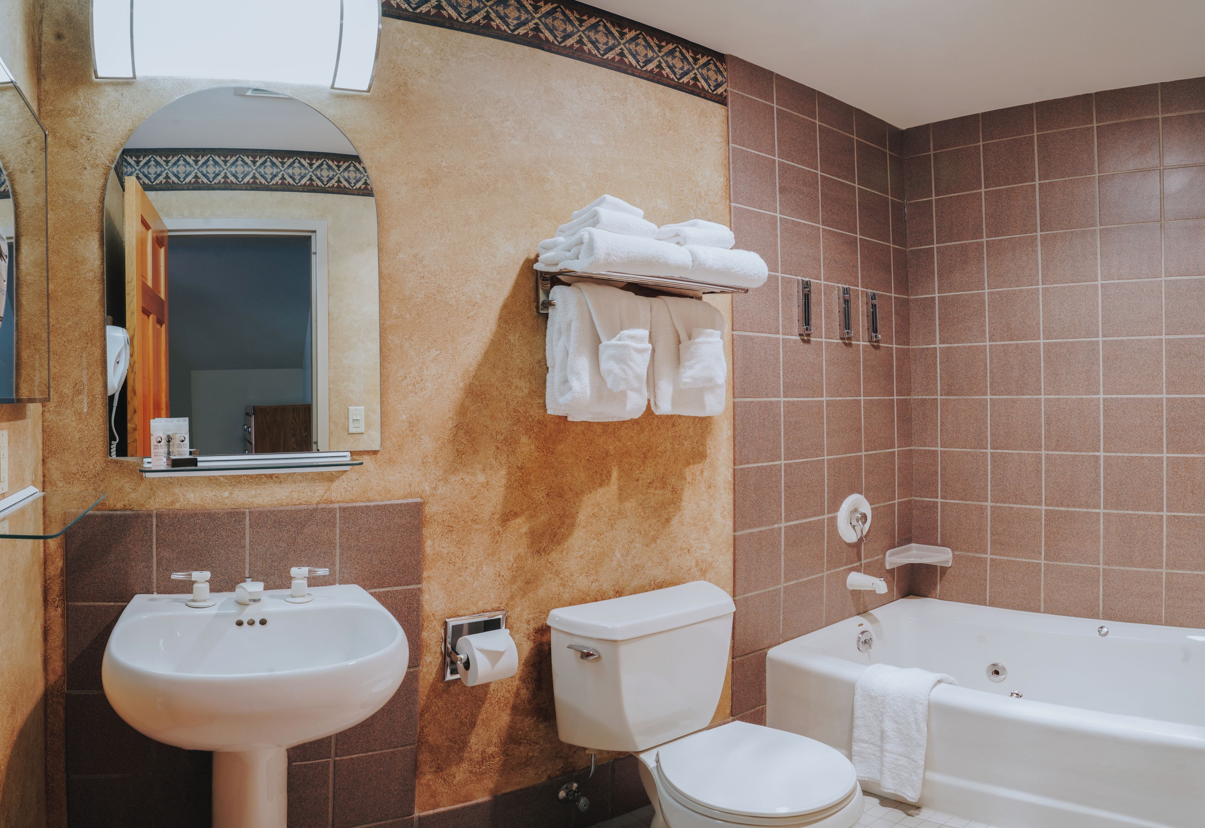 A bathroom with a sink, toilet, and bathtub.