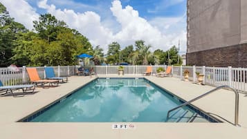 Seasonal outdoor pool, open 10:00 AM to 10:00 PM, pool umbrellas