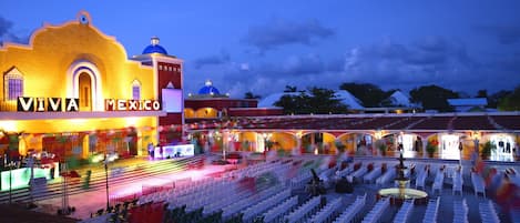 A venue with a stage and rows of chairs, labeled "VIVA MEXICO," suggesting a performance or event space.