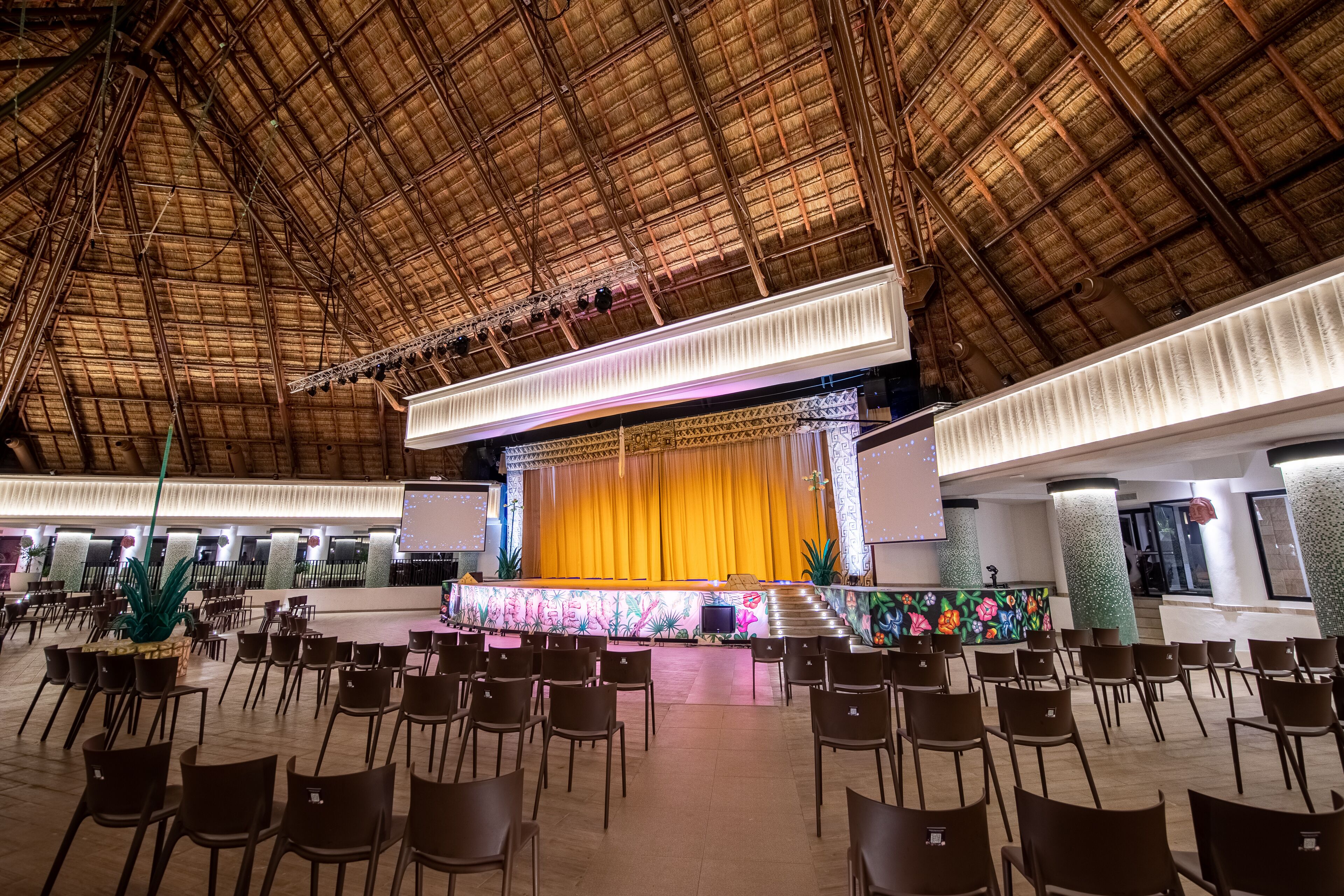 A spacious hall with a high ceiling and a stage at the front.