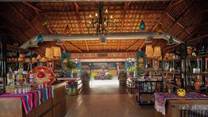 An interior with wooden beams, a bar area, and various items on shelves. - Bahia Principe Explore Tulum - Hyatt Inclusive Collection - All Inclusive (Akumal)