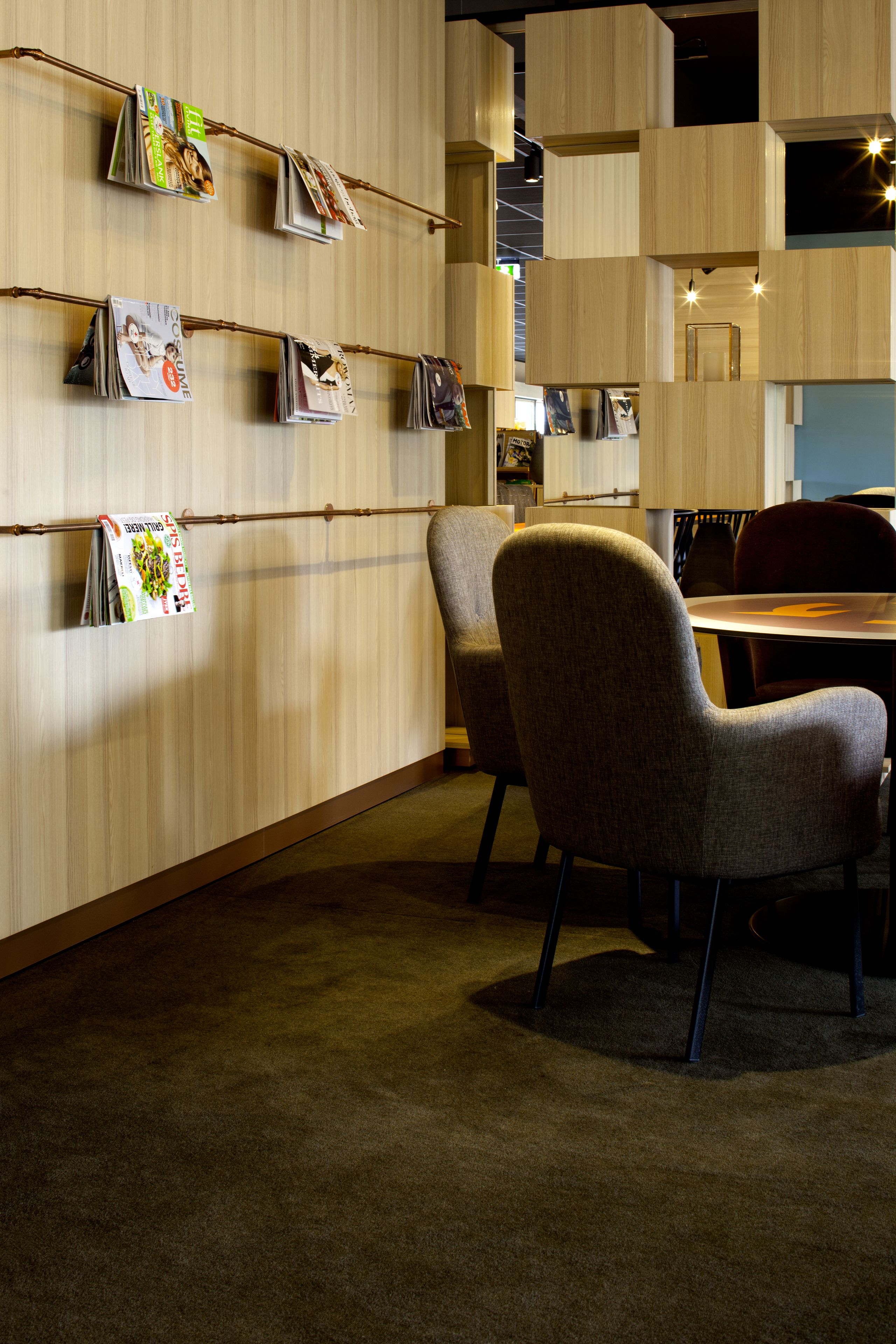 A modern interior with a wooden wall, a round table, and two chairs.