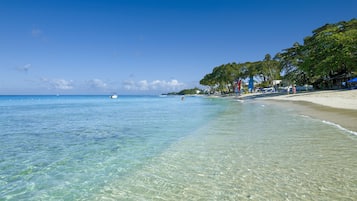 On the beach, white sand, free beach cabanas, sun loungers