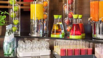 A juice bar with various fruit and vegetable juices, and a selection of glasses for serving.