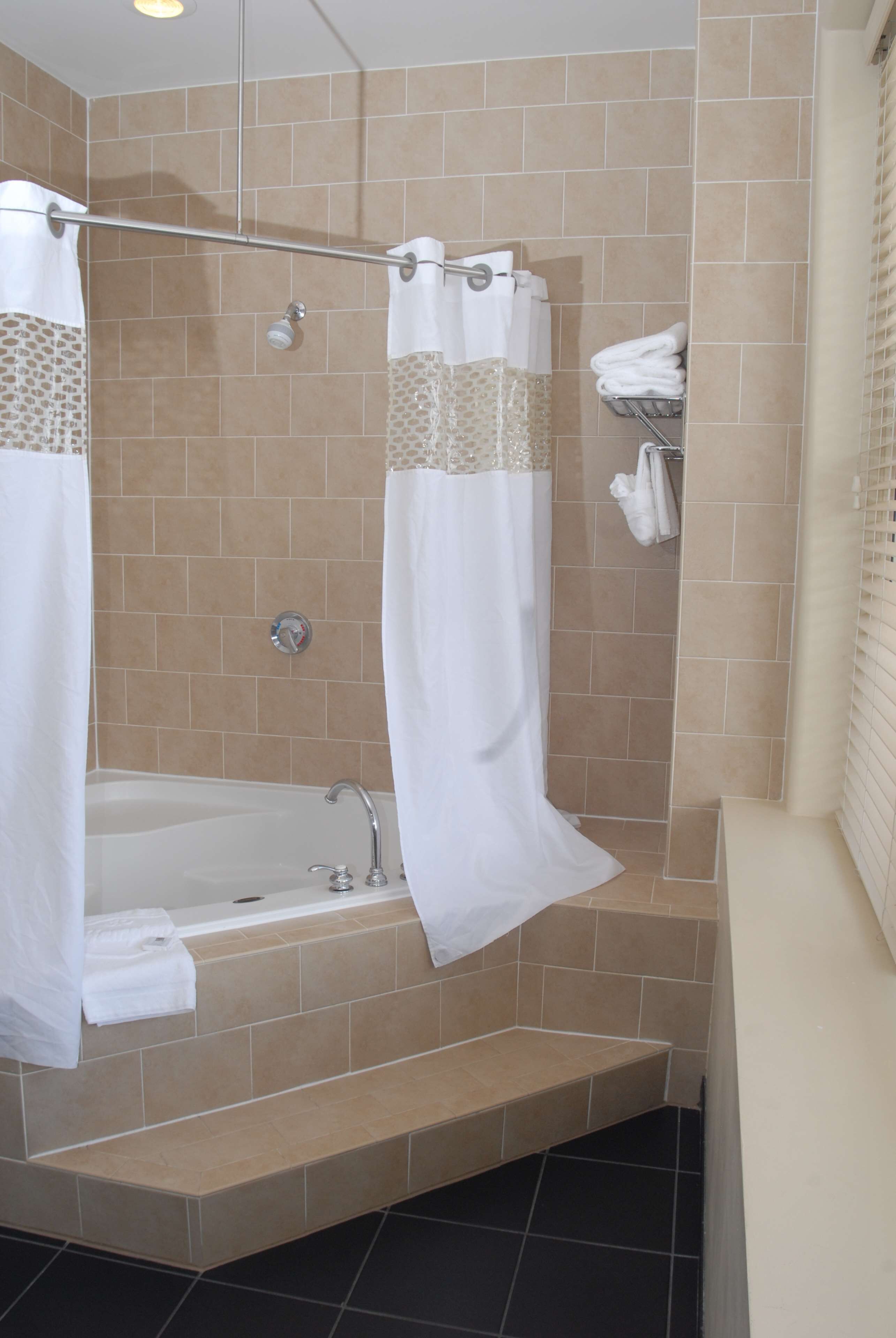 A bathroom with a bathtub, a shower, and a toilet.
