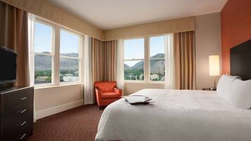 Suite, 1 King Bed, Non Smoking | Desk, laptop workspace, blackout drapes, iron/ironing board