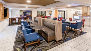 A modern hotel lobby with seating areas, a bar, and a reception desk. - Holiday Inn Express & Suites Tucson North – Marana by IHG (Tucson)