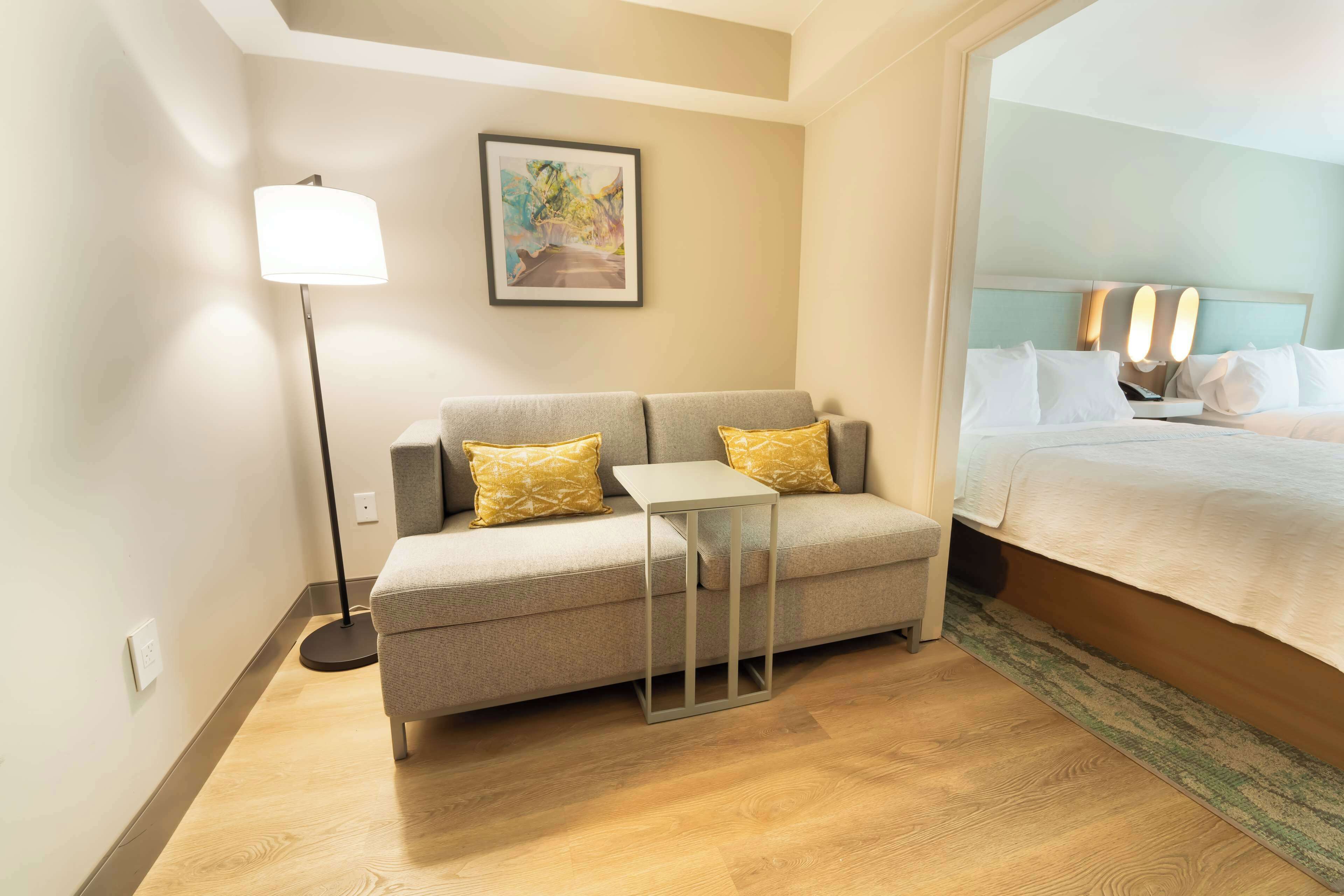 room, multiple beds, refrigerator | living area | flat-screen tv