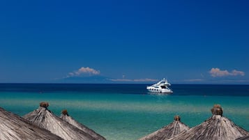 On the beach, sun-loungers, beach umbrellas, scuba diving