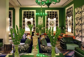 A room with a green color scheme, ornate mirrors, and a chandelier. - Kimpton Hotel Monaco Washington DC by IHG (Washington)