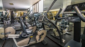 A gym with various exercise machines, including treadmills and elliptical trainers.