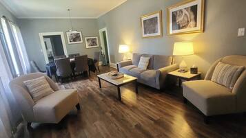 Suite, 5 Bedrooms, Non Smoking (Tyler) | Living area | 32-inch TV with cable channels, books