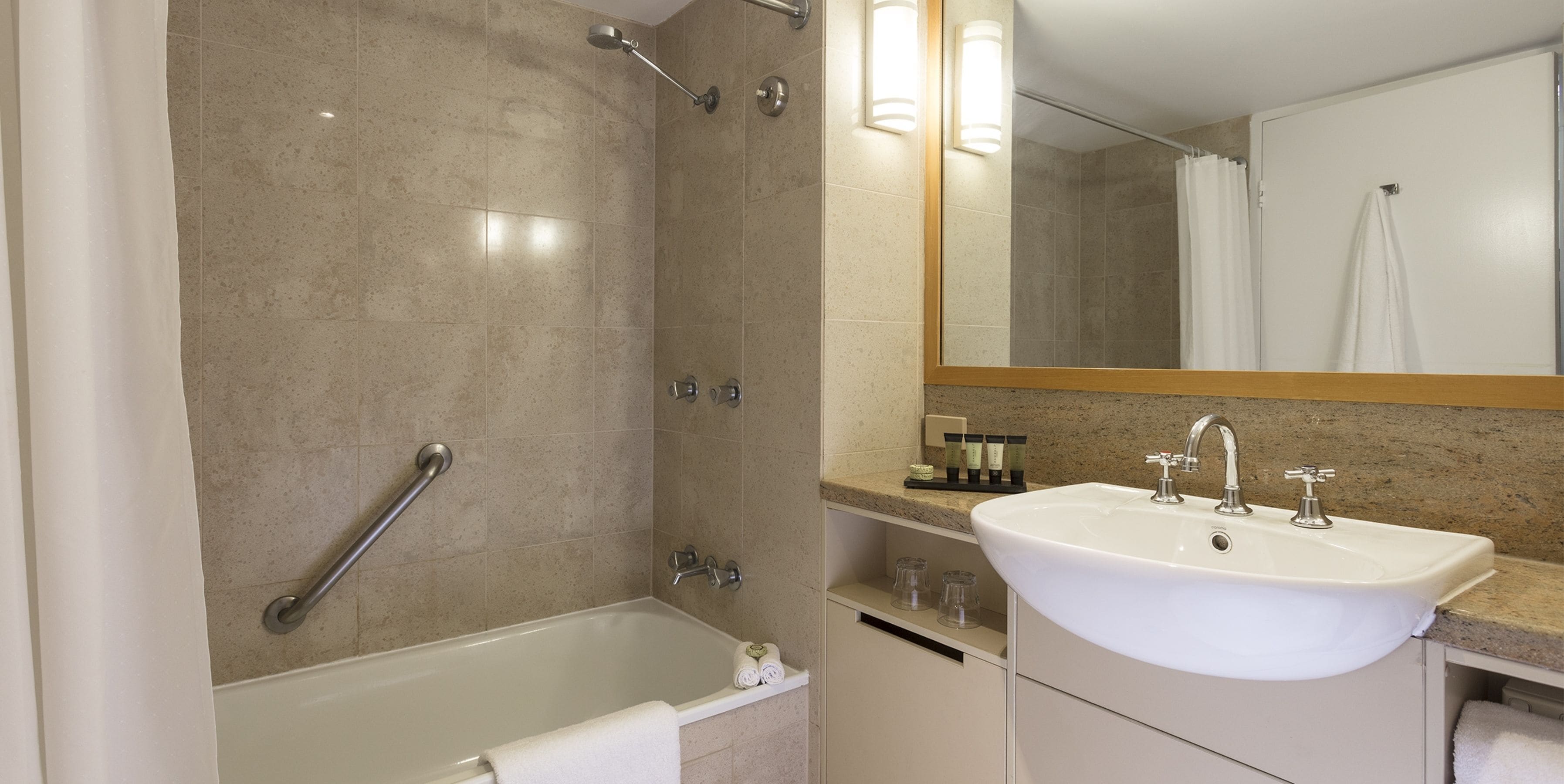 A modern bathroom with a bathtub, a sink, and a shower.