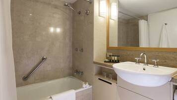 A modern bathroom with a bathtub, a sink, and a shower.
