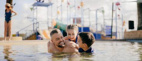 Outdoor pool, pool loungers, lifeguards on site