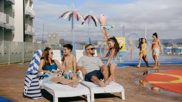 Outdoor pool, pool loungers, lifeguards on site