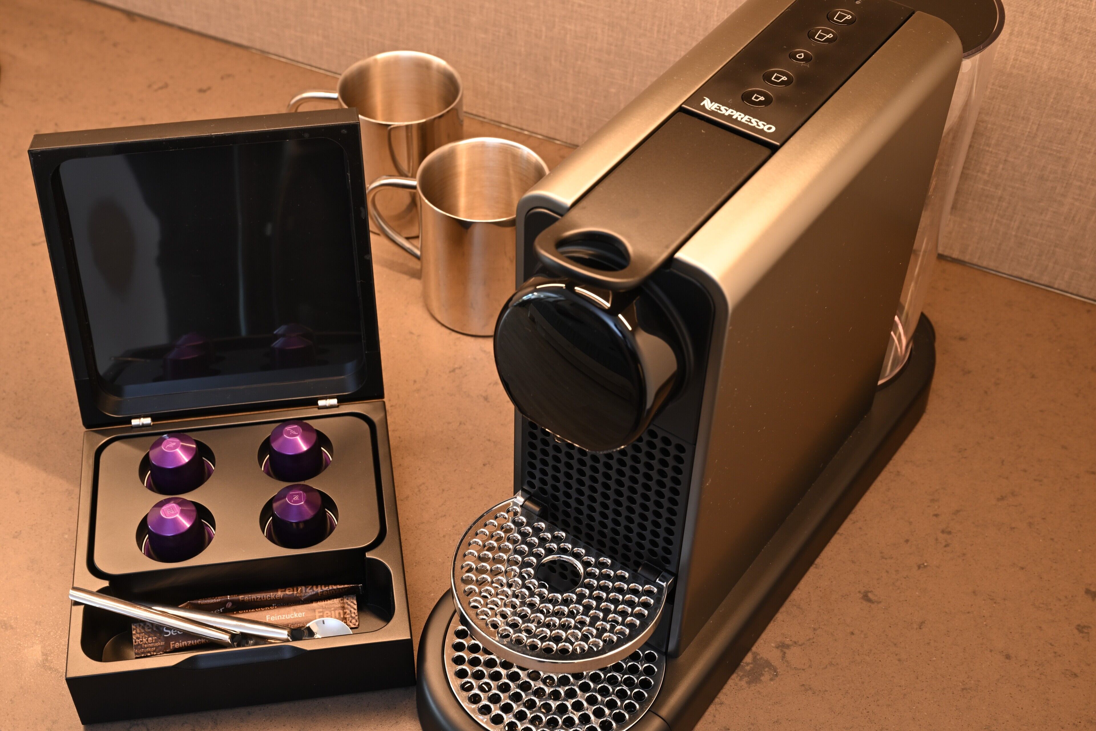 A coffee machine with a digital display and a coffee pod holder.