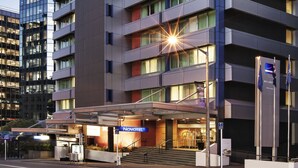A modern hotel with multiple floors, a prominent entrance, and a well-lit facade. - Novotel Wellington (Wellington)