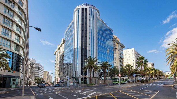 A modern hotel with a curved facade, large windows, and a prominent 'HOTEL ANTICO' sign. - Eurostars Atlantida (Santa Cruz de Tenerife)