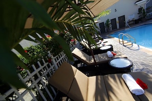 Seasonal outdoor pool, open 8:00 AM to 8:00 PM, pool umbrellas