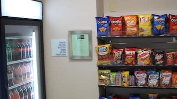 A vending machine with snacks and a refrigerator with beverages.