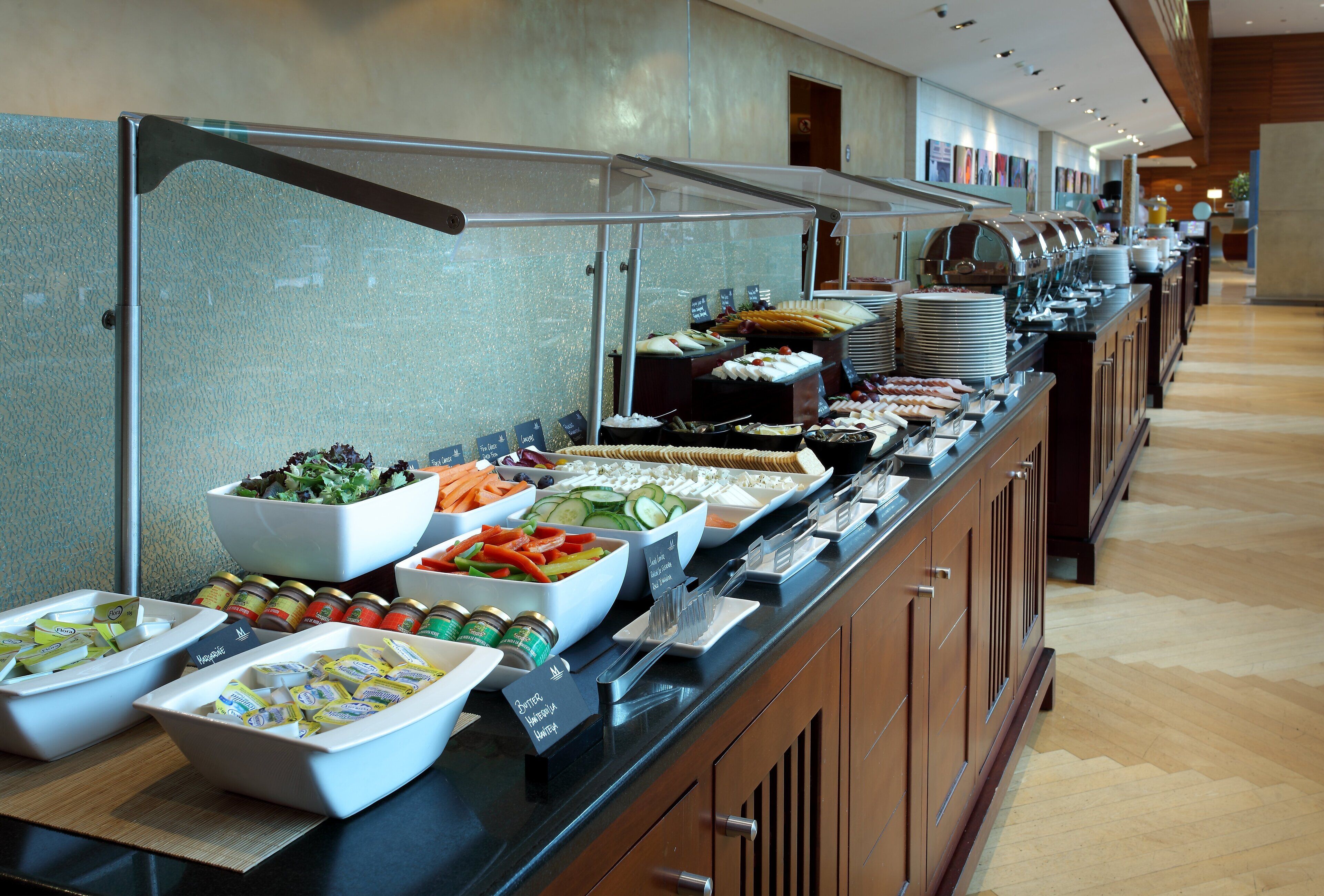 A buffet setup with various food items and condiments.
