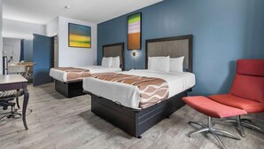A hotel room with two beds, a desk, and a red chair. - Best Western Magnolia (GAUTIER (PASCAGOULA AREA))