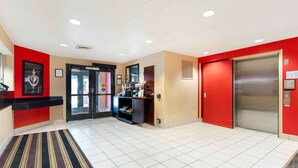 A hotel lobby with a reception desk, a coffee station, and an elevator. - Extended Stay America Suites Sacramento Vacaville (Vacaville)