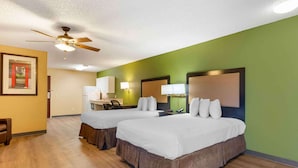 A hotel room with two beds, a ceiling fan, a desk with a chair, and a green wall. - Extended Stay America Suites Sacramento Vacaville (Vacaville)