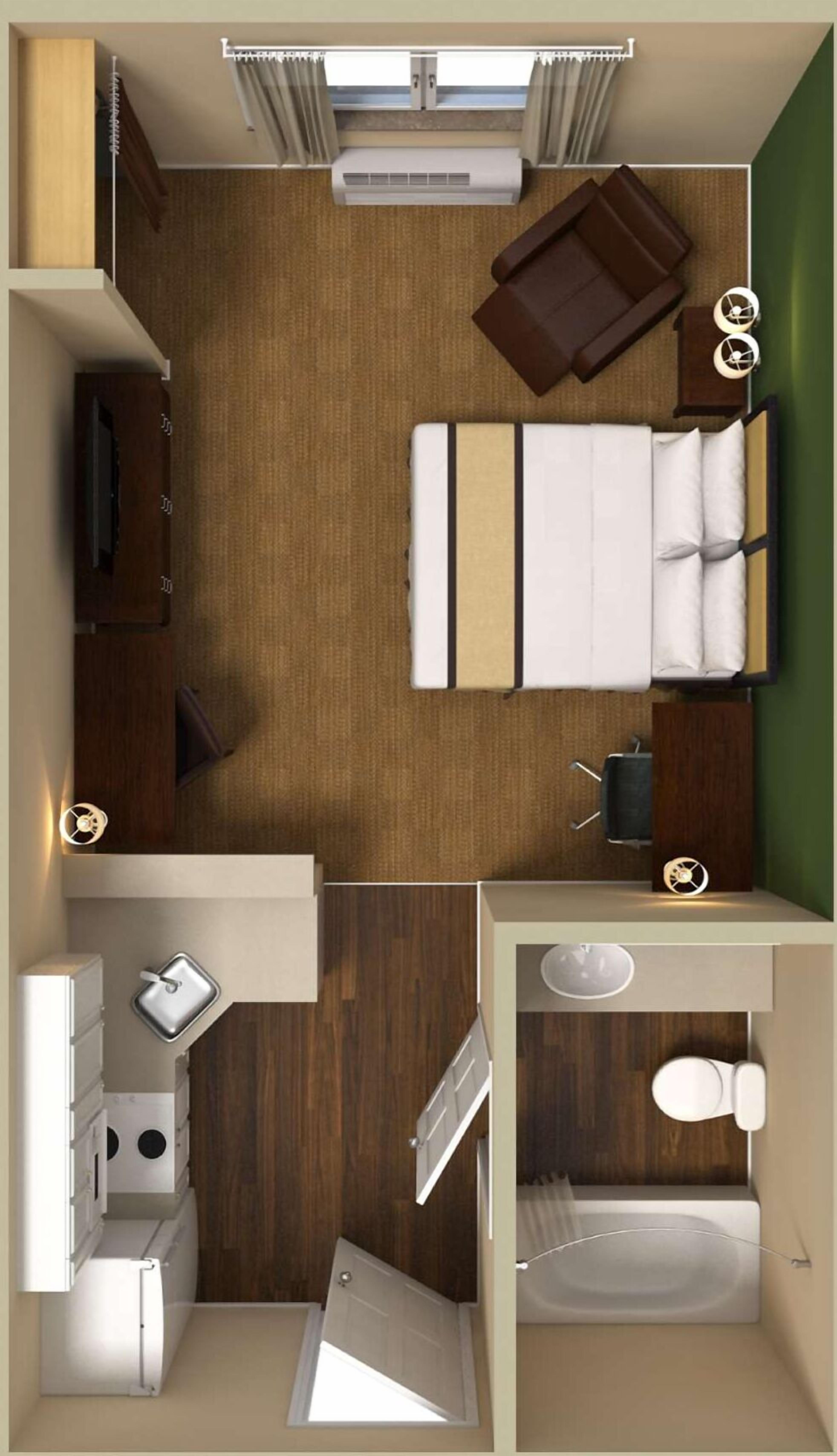 A compact room with a bed, a small kitchenette, a bathroom, and a window.
