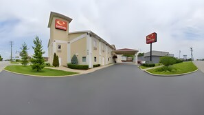 A Qdoba restaurant with a modern design, featuring a large sign, a parking lot, and well-maintained landscaping. - Econo Lodge Louisville Airport (Louisville)